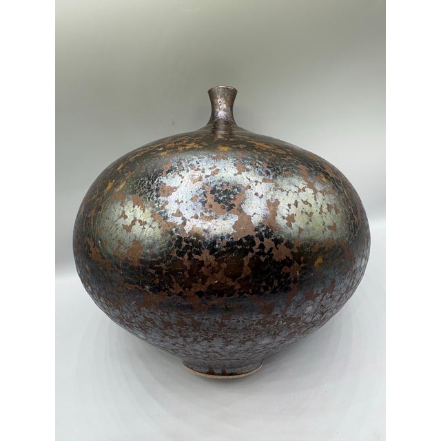 Artisan made ceramic weed vase. Intense gun metal dark color vase with mottled copper color spots. Classic shape and...