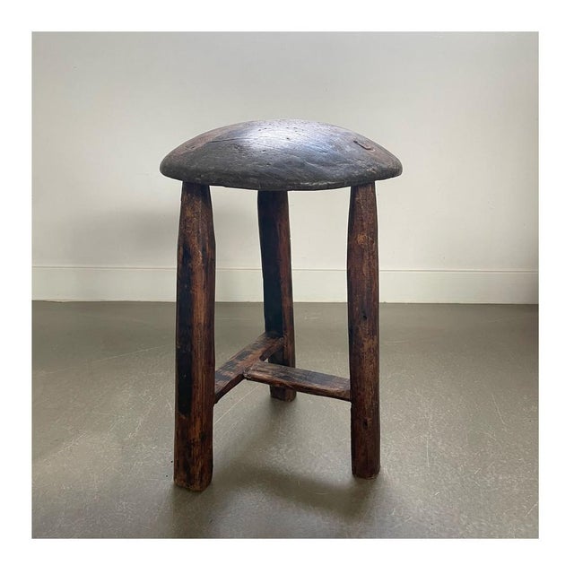 Antique tripod wooden stool, great shapes. Brutalist, wabi sabi style. Striking are its round top and the way the three...