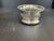 Vintage Reticulated Silver Plate Wood Wine Bottle Coaster in good estate condition. There is a spot where the silverplate...