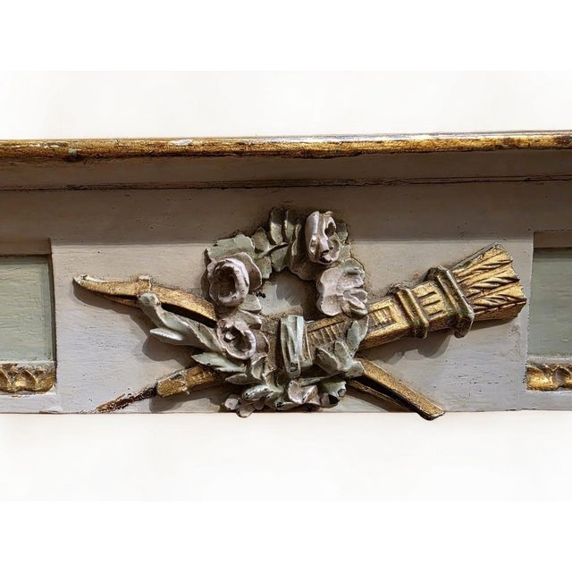 A polychrome Louis XVI style console table resting on two fluted and tapered legs joined by a stretcher. It is decorated...