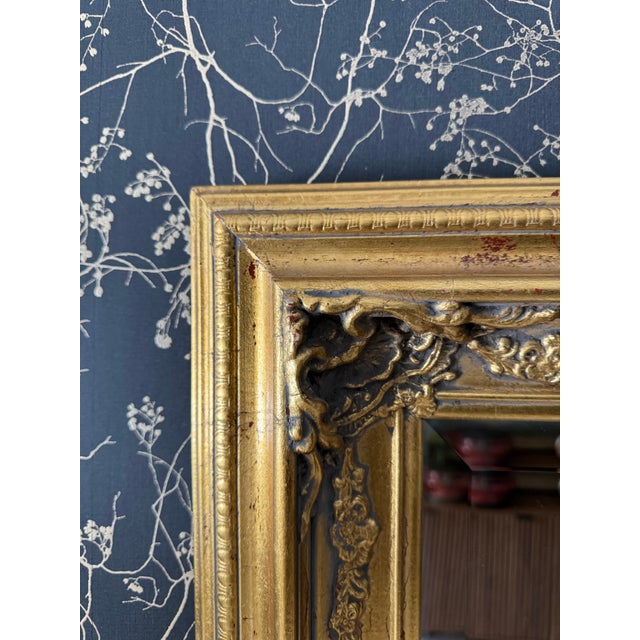 Statement-size vintage gilt wall mirror with an elegant, Old-World presence. The frame features beautifully sculpted...
