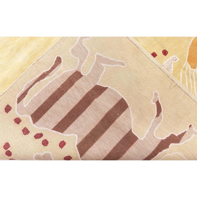 This striking modern Art Deco-inspired rug features a luminous golden-yellow field enlivened by whimsical animal figures...