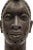Oni head. The face is covered with vertical scarification marks. The dignitary's bronze head is topped by a traditional...