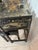 Elegant black lacquered chinoiserie vanity and stool set with richly decorated gilt scenic and floral motifs. Piece...