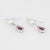 Elegant pair of estate pink tourmaline, diamond & cultured pearl earrings crafted in 18k white gold. Faceted pear cut pink...