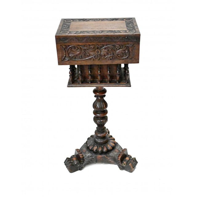 A padouk wood teapoy finely carved on an elaborate tri form base terminating a paw feet Teapoy - a small three-legged...