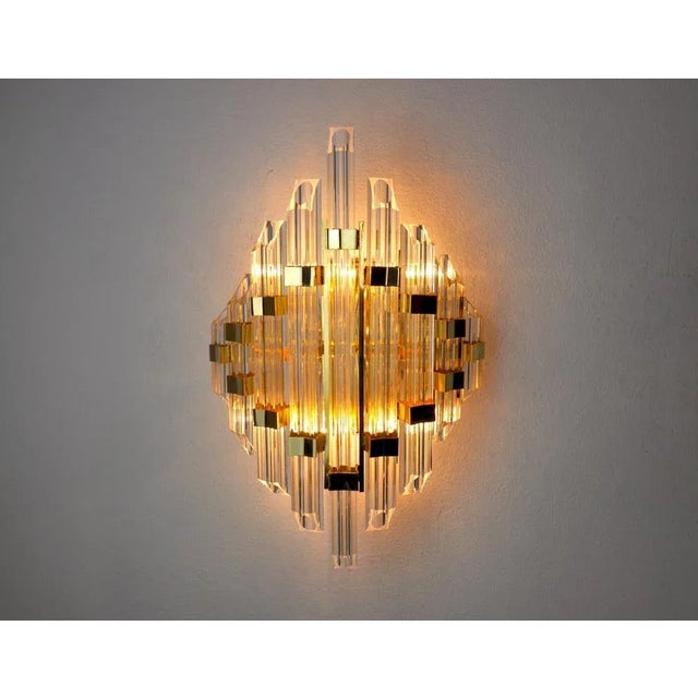 Very beautiful and large tubular Venini wall light designed and produced in Italy in the 70s. Tubular cut glass and gilded...