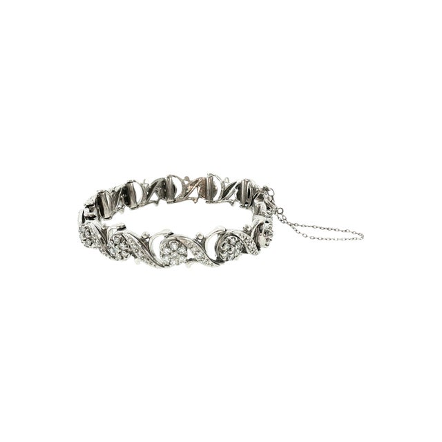 A mid 20th-century link bracelet featuring 130 white single-cut diamonds. The diamonds have a total carat weight of 3.5,...