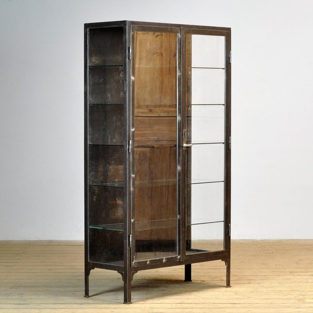 Medical cabinet from the 1930s. The cabinet is produced in Hungary and is made of thick iron and glass. The lock and...