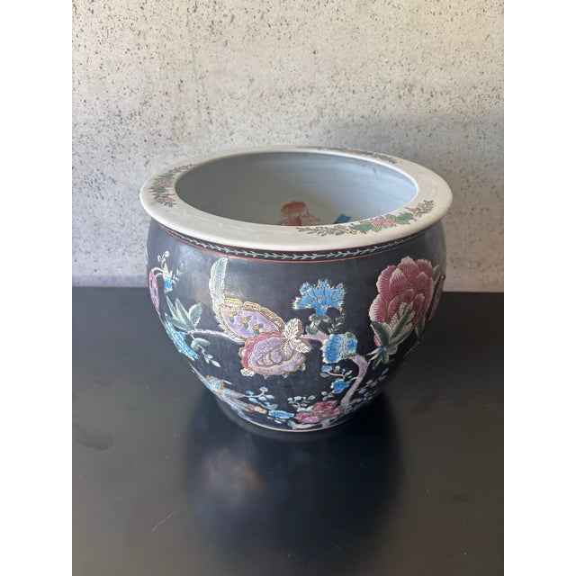 Vintage Chinese import porcelain planter with a dramatic black ground and colorful hand-painted floral, butterfly, and...