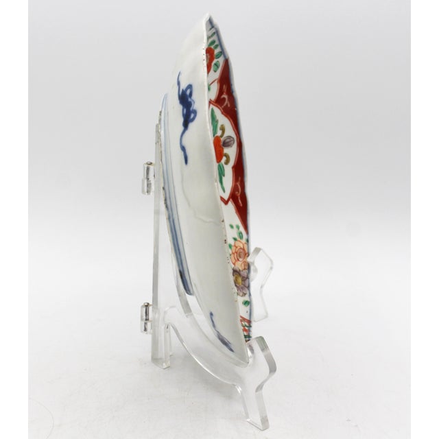 Circa 1880 shaped Imari plate, Japanese. Porcelain. Lattice panels flanked by floral & cartouche reserves. Underglaze blue...