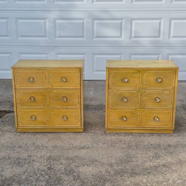 This is a very cool pair of vintage Hollywood regency style yellow dressers with iconic bones. Check out the 3 equal sized...