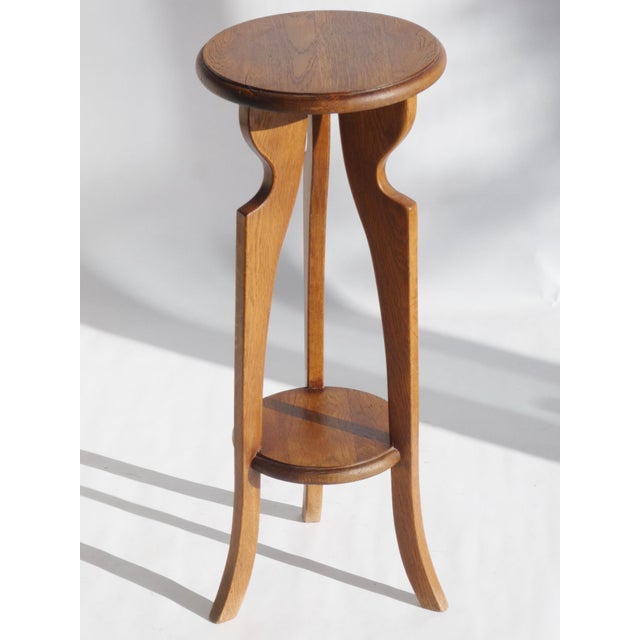 A vintage Art Deco two tiered pedestal made in Amsterdam School style. The table is from the 1930's and is made in the...