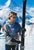 Shades and Skis by Toni Frissell A skier checks her skis before beginning the descent down a mountain in Zermatt,...