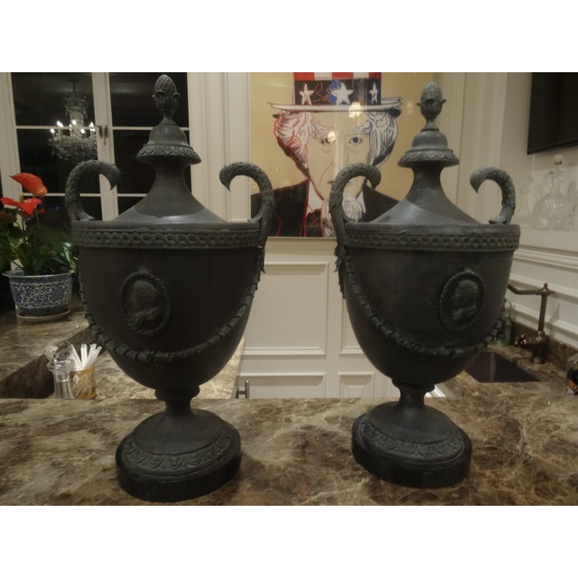 A striking pair of Neo Classical Style cast Bronze Urs high quality with foliate swag decoration and scholars Profile