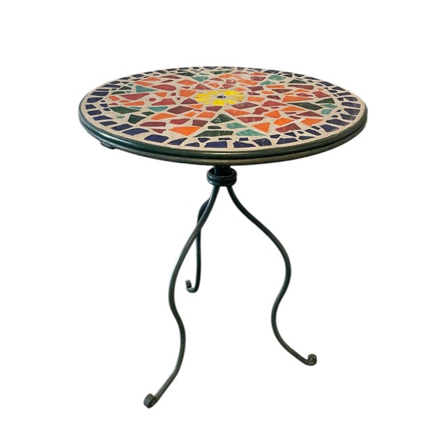 Charming vintage mosaic tile bistro table featuring a hand-laid multicolor tile top in vibrant shades of cobalt blue,...