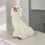 A mid-twentieth-century Staffordshire-style mantel figure modelled as a seated King Charles spaniel, circa 1940–1960, with...