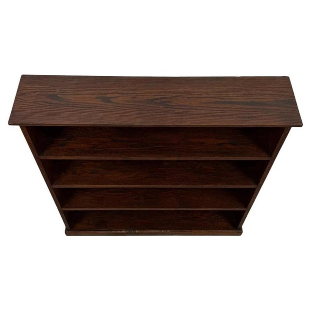 A handsome early 20th-century English open bookcase, finely crafted from oak and distinguished by its compact proportions,...
