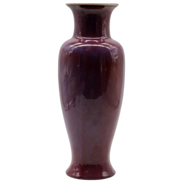 Antique Chinese baluster form vase in a deep oxblood red glaze with flambe runs and a lavender halo at the shoulder. The...