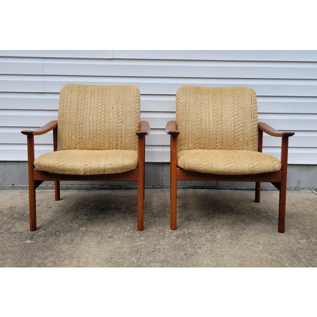 Pair of solid teak lounge side chairs designed by Alf Svensson for Dux circa 1960s. This pair has a vintage woven...