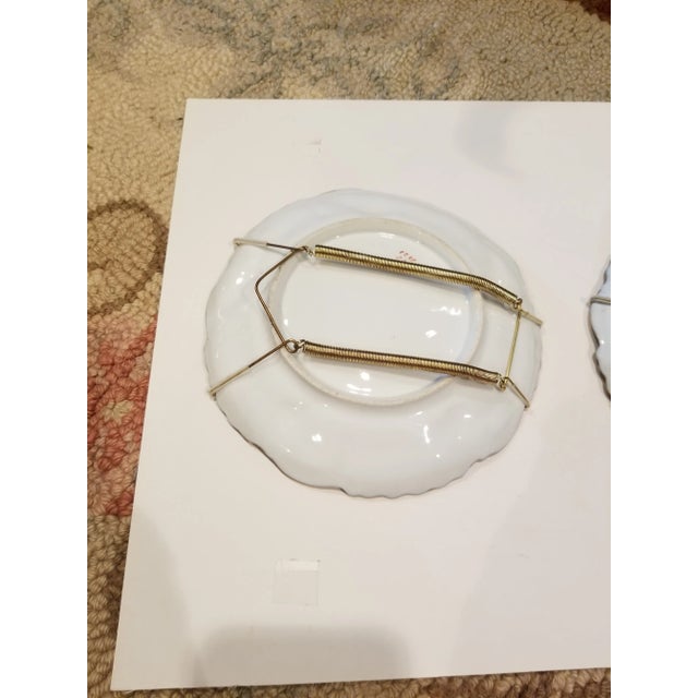 Pair of cobalt blue and gold decorations with transfer cherub scenes on each one.