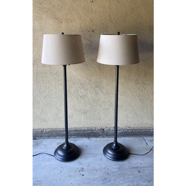 Pair of Pottery Barn adjustable Chelsea floor lamps in bronze finish with shades. Cast of steel, zinc and brass. Large...