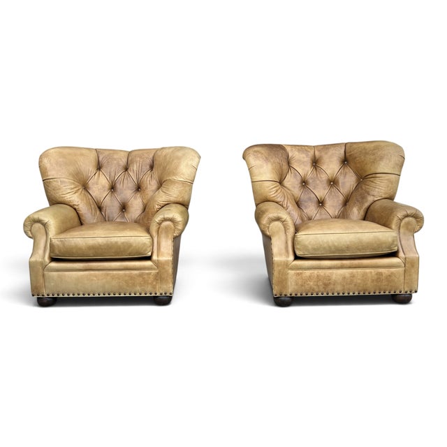 This pair of oversized tufted leather armchairs combines classic English design with the tailored elegance often...