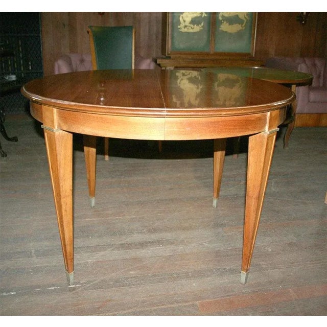 Round extention table (no leaves) with bronze trim and bronze feet.