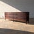 A beautifully proportioned Danish modern long dresser by Svend Langkilde, crafted in richly figured rosewood during the...