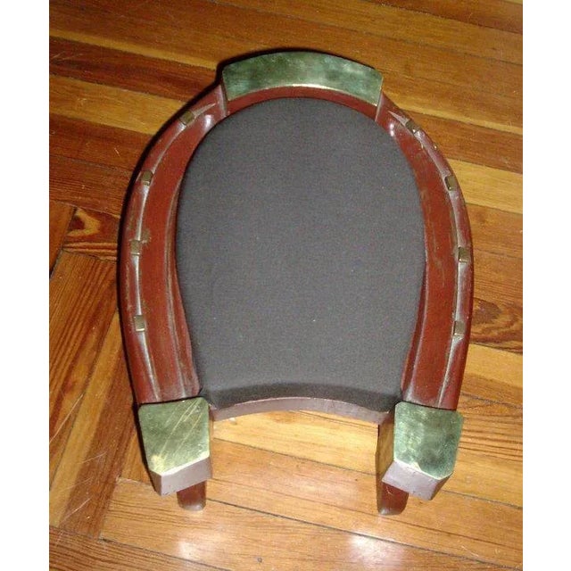 A lovely horse shoe shaped foot stool or ottoman. This is a very high quality object with expertly fitted brass caps and...