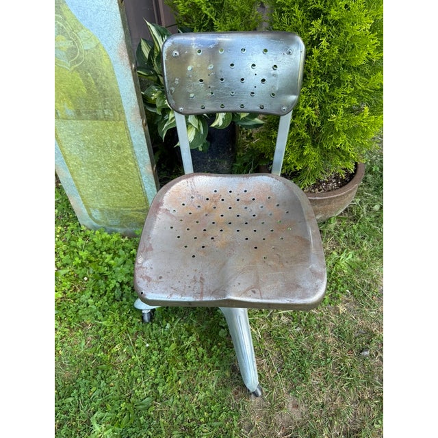 A vintage Goodform Manufacturing of Youngstown Ohio industrial adjustable swivel chair, mid-20th century, featuring a...