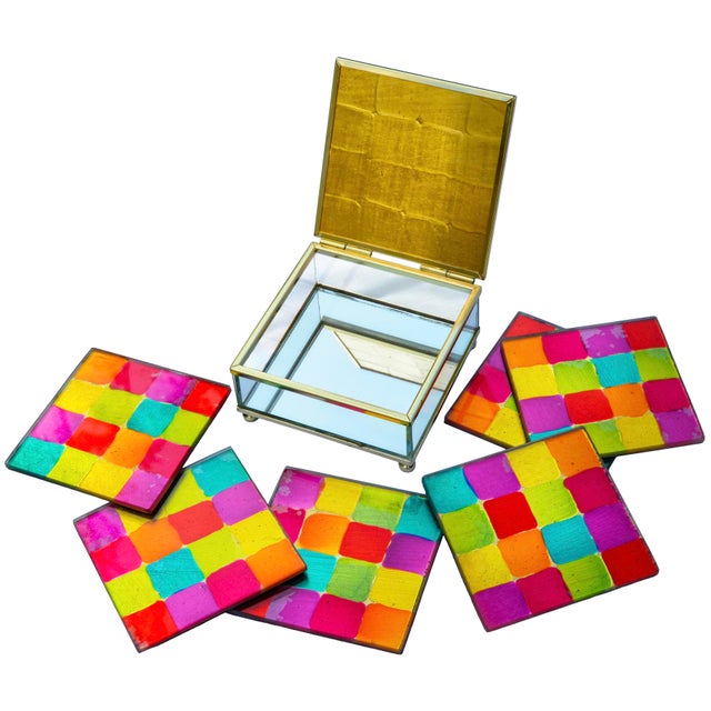 Impressive midcentury set of six coasters housed in matching caddy, thoughtfully handmade in an elegant squared glass with...