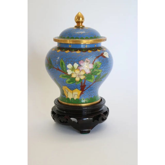 Hand painted cloisonne jar with wood base from China.