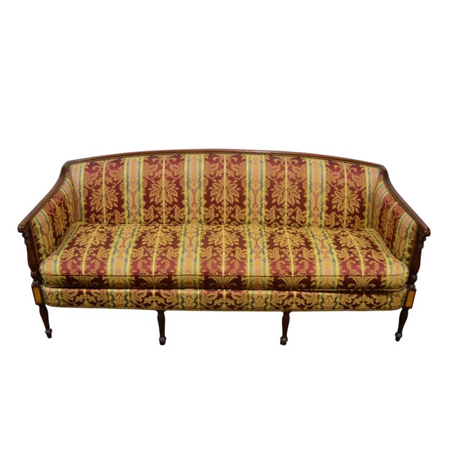 A Hickory Chair Co. Sheraton sofa with a mahogany frame and blonde maple inlay. The sofa is upholstered in a high end...