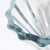 This luminous Mid-Century Modernist Strombergshyttan Blue Crystal Fluted Glass Bowl originated in Sweden, circa 1960. The...