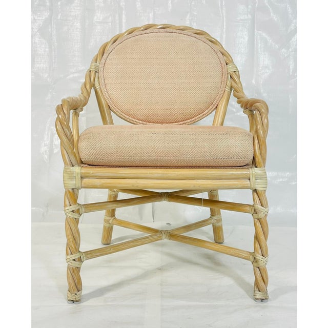 This vintage rattan armchair was designed and manufactured in San Francisco, California by McGuire, one of the most...