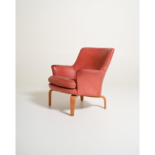 Pink leather armchair with bentwood frame and removable cushion. Designed by Arne Norell in 1967, Norell label present....