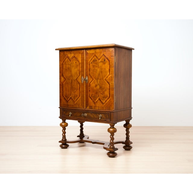 An exceptional German cocktail cabinet crafted from solid walnut and exquisite walnut veneers, dating to circa 1900....