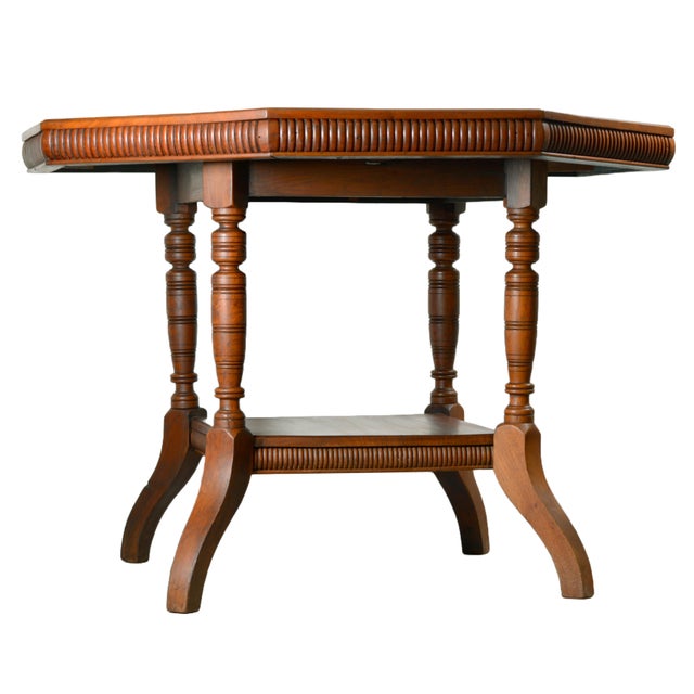 An elegant walnut occasional table dating approximately to the early 20th century, distinguished by its octagonal solid...