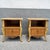 A charming pair of vintage French Provincial style nightstands featuring elegant bombe silhouettes, warm burl wood...