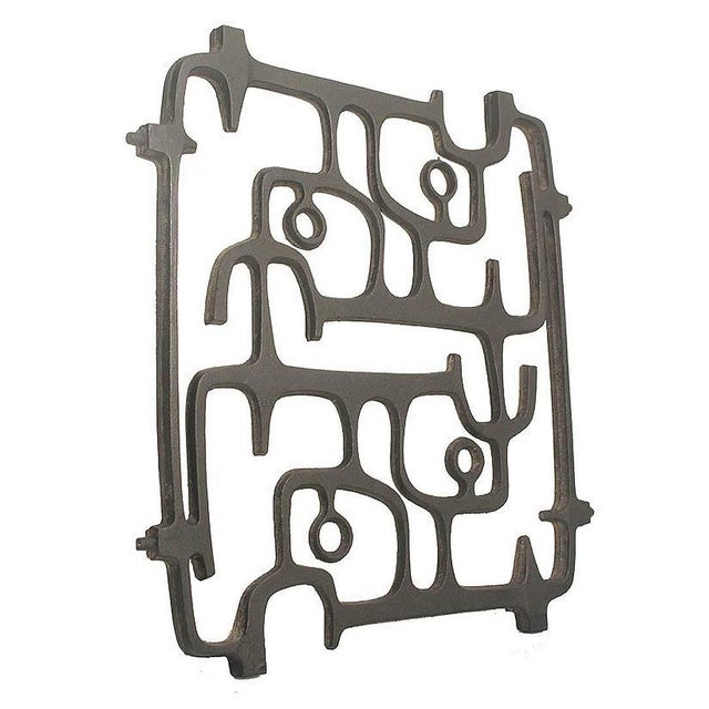 Extraordinary 1950s mid-century cast iron wall sculpture with an interlaced design in the style of the sculptors of the...