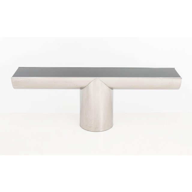 J. Wade Beam for Brueton "Tee" Console Table, black glass top above T-shape stainless steel base. 30.25" H x 84" W x 18"...
