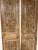 A striking pair of narrow arched door panels, hand-carved in an antique style with an intricate floral motif running the...