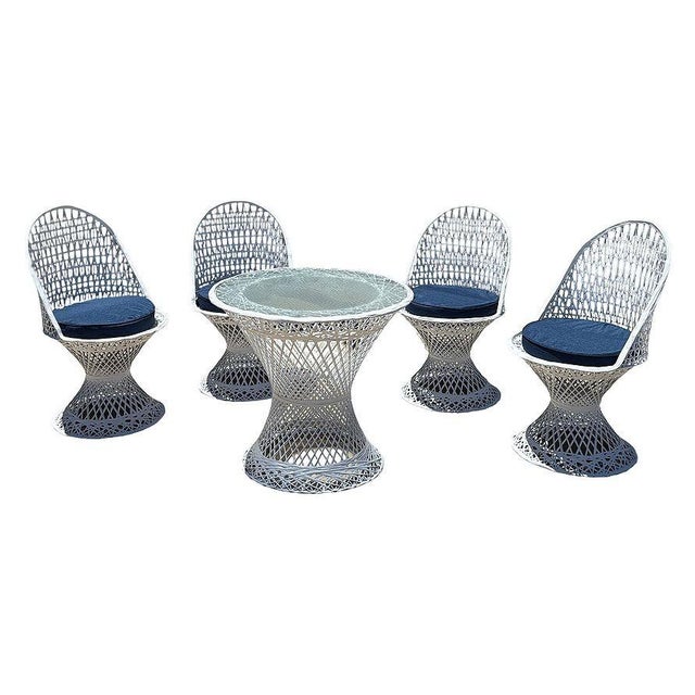 Exceptional five-piece Mid-Century Modern spun fiberglass patio dining set in the style of Russell Woodard. The set...