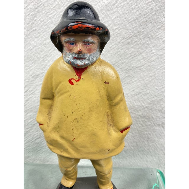 Vintage doorstop of a bearded fisherman in his yellow rain gear and black hat. Overall very good paint with some small...