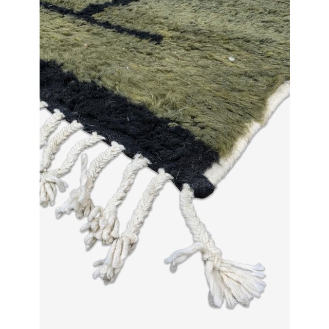 Modern Boujad Rug | Handwoven Wool Rug in Green with Freehand Black Grid This modern Boujad rug grounds itself in a rich,...