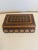 A beautifully hand-carved wooden keepsake box featuring intricate geometric and floral motifs accented by delicate...