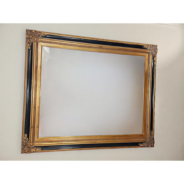 This sophisticated wall mirror from The Uttermost Company (Model #C4896) features a stunning Neoclassical / Regency...
