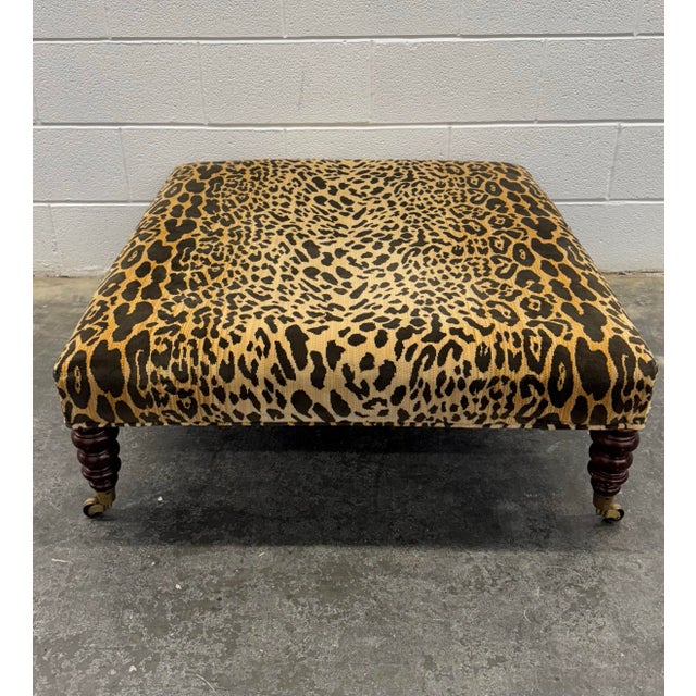 George Smith Standard Style Ottoman on turned legs with brasses casters in a textured knit leopard print fabric. There is...