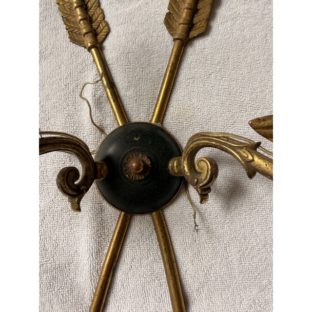 These are a pair of vintage French Empire Revival brass and enamel wall sconces, featuring a distinctive arrow motif and...